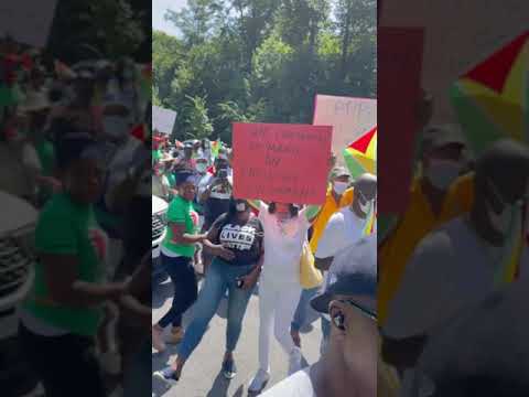 Protesters in Anti Racism Guyana Protest Confront Government Agent.